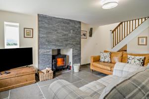 a living room with a couch and a fireplace at 2 Bed in Ormathwaite oc-s32385 in Applethwaite