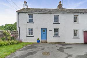 a white house with a blue door at 2 Bed in Ormathwaite oc-s32385 in Applethwaite