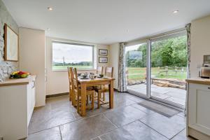 a kitchen and dining room with a table and chairs at 2 Bed in Ormathwaite oc-s32385 in Applethwaite