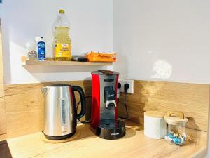 a kitchen counter with a coffeemaker and a coffee maker at Chez le Padré in Olivet