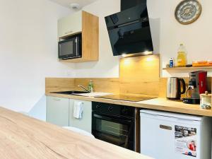 a kitchen with a sink and a dishwasher at Chez le Padré in Olivet