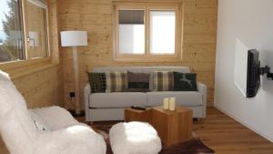 a living room with a couch and a table at Chalet Sofia in Bettmeralp