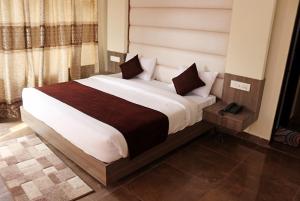 a bedroom with a large bed in a room at Hotel Trihari in Rishīkesh +60 photos