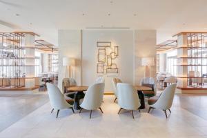a dining room with a table and chairs at ANA InterContinental Manza Beach Resort by IHG in Onna