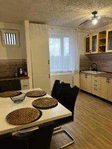 a kitchen with a table and chairs in a room at Apartament Atrium Gara Afi in Arad