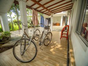two bikes parked on the porch of a house at Man Guest Polonnaruwa in Polonnaruwa