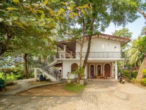 a house with a staircase leading up to it at Man Guest Polonnaruwa in Polonnaruwa