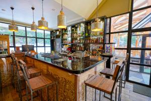 a bar in a restaurant with chairs and tables at Hotel Nevados de Chillan in Nevados de Chillan