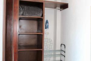 a wooden book shelf in a room at Hotel ESTRELLA in Zacatlán +1 photo