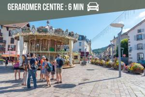a group of people standing in front of a carousel at La Ferme des 3 lacs in Xonrupt-Longemer