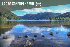a picture of a lake with rocks in the water at La Ferme des 3 lacs in Xonrupt-Longemer