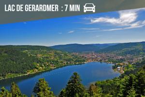a view of a lake der garderen and a town at La Ferme des 3 lacs in Xonrupt-Longemer