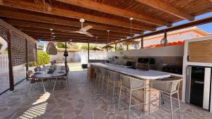 an outdoor kitchen with a table and chairs and a ceiling at Casa Amis Calpe in Calpe