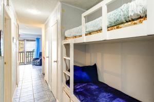 a room with two bunk beds in a room at Steps to North Beach: Gem w/ Ocean-View Balcony! in Corpus Christi