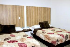 a hotel room with two beds in a room at Hotel ESTRELLA in Zacatlán