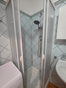 a shower in a bathroom with a toilet and a sink at Casa Alba Marina in Marzamemi