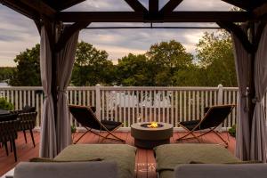 a gazebo with chairs and a table on a deck at Lindenwood Inn in Southwest Harbor
