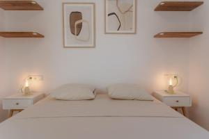 a bedroom with a white bed with two night stands at Aelia Kastraki Beach House in Kastraki