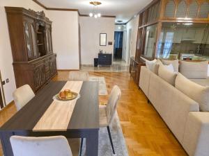 a living room with a table and a couch at Alexandra Welcome Maxi Place in Kastoria +21 photos