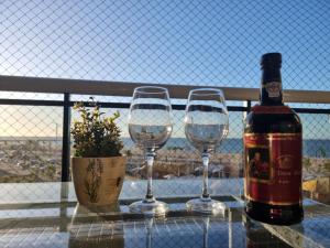 a bottle of wine and two wine glasses on a table at Apart 203 Vista Mar in Fortaleza +1 photo