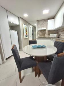 a kitchen with a table and chairs in a room at Apart 203 Vista Mar in Fortaleza