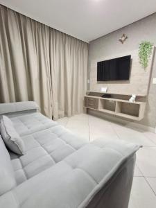 a bedroom with a bed and a flat screen tv at Apart 203 Vista Mar in Fortaleza