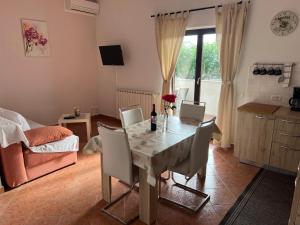 a dining room with a table with chairs and a couch at Apartment Vesna in Veleniki