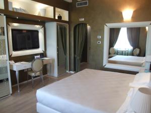 Postel nebo postele na pokoji v ubytování Hotel Morgana