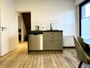 a kitchen with a sink and a counter top at Altstadt Apartment Deluxe 3 in Haltern