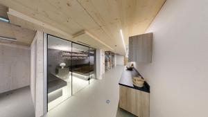 a kitchen with white walls and wooden ceilings at Ferienhotel Fuchs in Söll