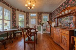 a dining room with a table and a large wooden cabinet at The Allen House in Ridgefield