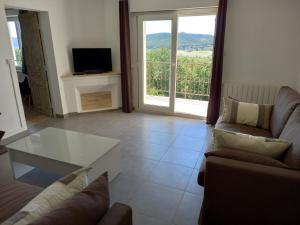 a living room with a couch and a table at La maison in Cruviers-Lascours