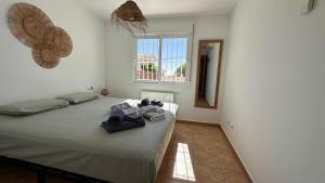 a bedroom with a bed with towels on it at Casa Amis Calpe in Calpe