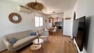 a living room with a couch and a table at Casa Amis Calpe in Calpe
