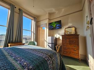 a bedroom with a bed and a large window at Hotel Planter in La Conner