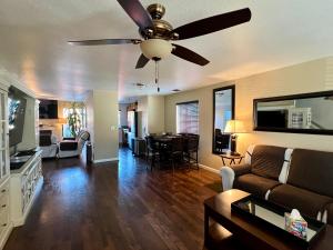 a living room with a couch and a ceiling fan at By Popular Demand - Richmond in Richmond