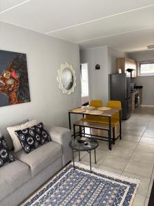 a living room with a couch and a table at Monochrome View in Nelspruit