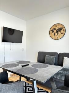 a living room with a table and a couch at Resort Winklfeld 6a in Oberndorf bei Schwanenstadt