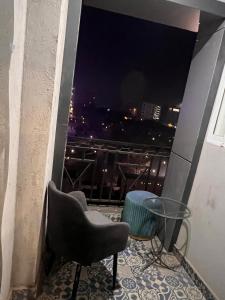a balcony with a view of a city at night at HNC Arcade in Dargai +1 photo