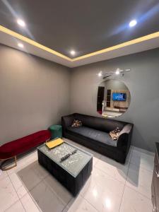 a living room with a couch and a table at HNC Arcade in Dargai