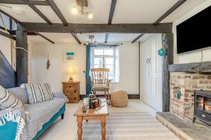 a living room with a couch and a fireplace at 1 Bed in Looe oc-l30002 in Looe