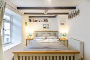 a bedroom with a large bed with two night stands at 1 Bed in Looe oc-l30002 in Looe