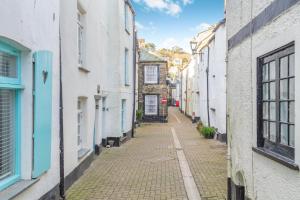 an alley in an old town with white buildings at 1 Bed in Looe oc-l30002 in Looe