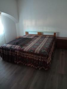 ein Bett in einem Zimmer mit einer Decke darauf in der Unterkunft Seconda Casa in Boves