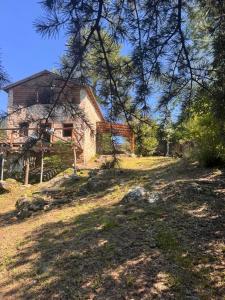 a house on the side of a hill with trees at Stone Cabin, PETRA HAUS in Cuesta Blanca