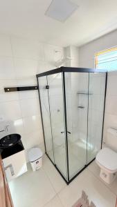 a glass shower in a bathroom with a toilet at Hotel Diamond Exclusive in Oiapoque
