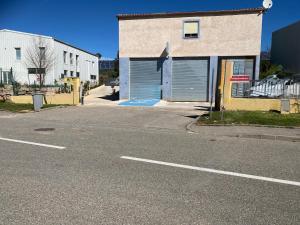 an empty street with a building with a garage at studio2 in Vins-sur-Caramy