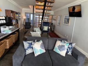 a living room with a gray couch with pillows at Sea Paradise in Wilderness +52 photos