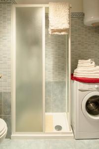 a laundry room with a washing machine in a bathroom at Prali Ski House - 4beds - Parking - Garden in Prali +33 photos