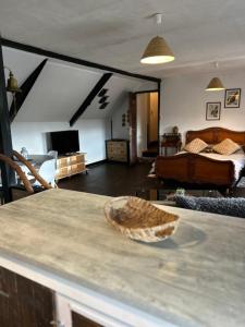 a living room with a room with a bed and a table at Chambre d'hôte Mara in Corlay
